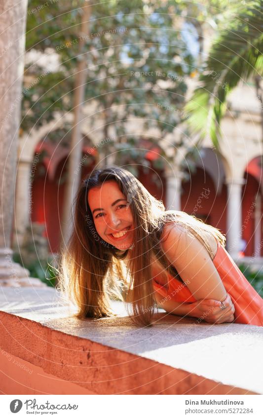 Happy young woman in red dress smiling and looking to the camera tilted perspective happy Woman Smiling Joy Adults portrait Laughter Lifestyle Human being