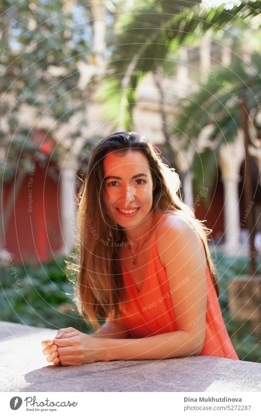 Happy young woman in red dress smiling and looking to the camera tilted perspective happy Woman Smiling Joy Adults portrait Laughter Lifestyle Human being