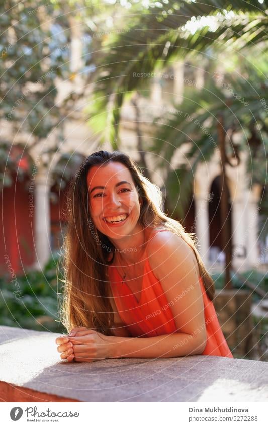 Happy young woman in red dress smiling and looking to the camera tilted perspective happy Woman Smiling Joy Adults portrait Laughter Lifestyle Human being