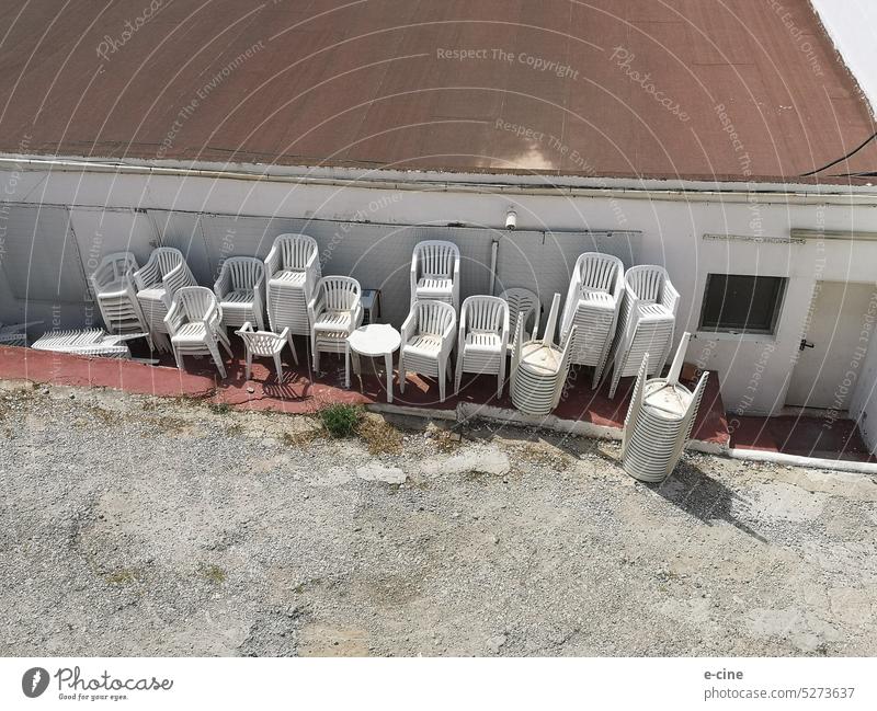 A collection of monobloc chairs and tables in the backyard monoblock monoblock chair Furniture Chair Seating Deserted Places Seating capacity Row of seats Event