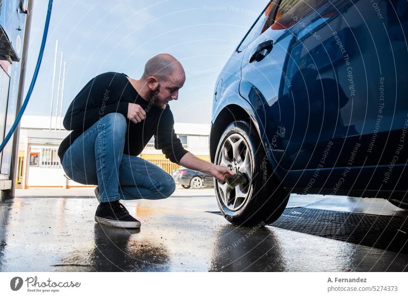 Cleaning car using active foam. Man washing his car on self car-washing  Stock Photo - Alamy