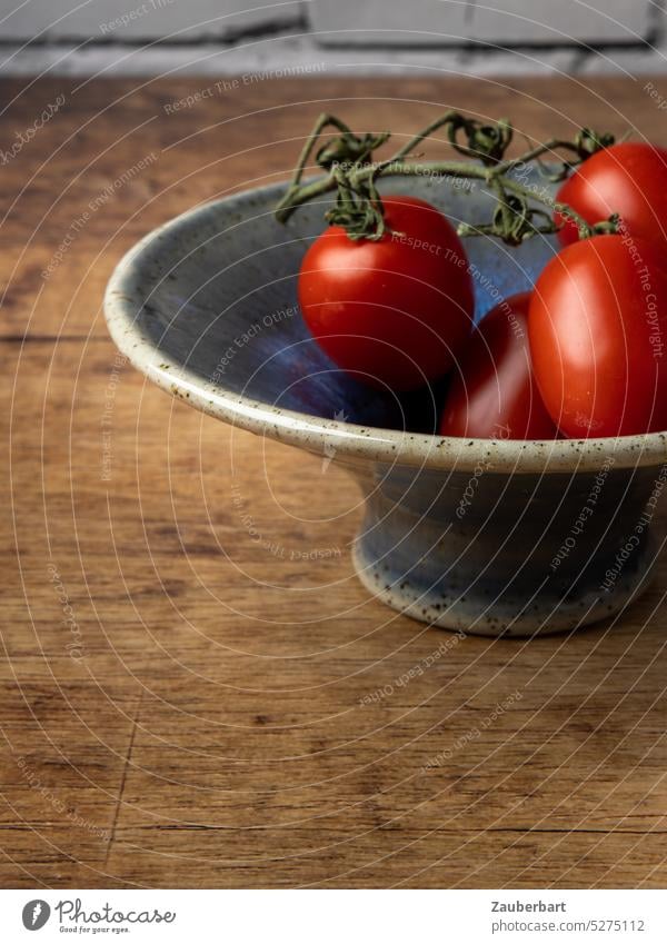 A handmade glazed bowl with tomatoes on the table, healthy food shell Do pottery pottered Blue Red Food Vegetable Fresh Healthy salubriously Nutrition vegan