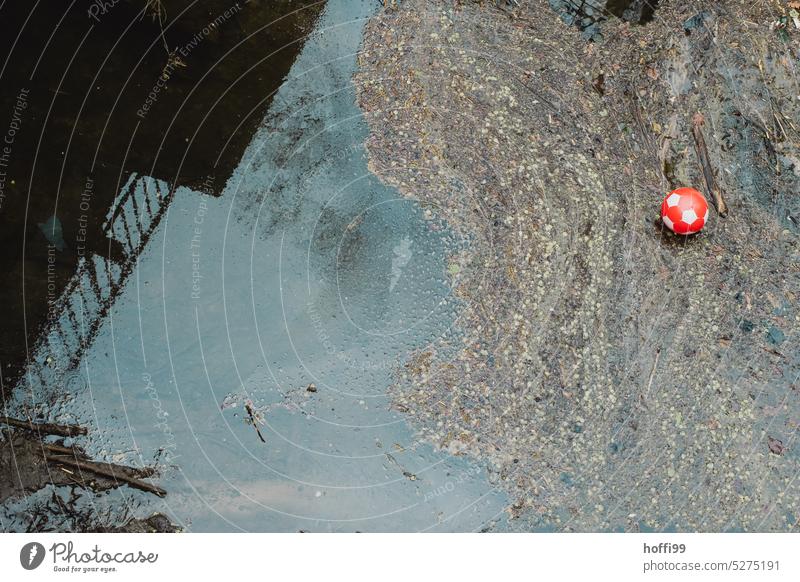 red ball in dirty water