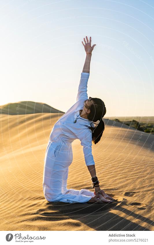 Back View Of Young Woman Meditating In Lotus Pose In Desert Stock Photo -  Download Image Now - iStock