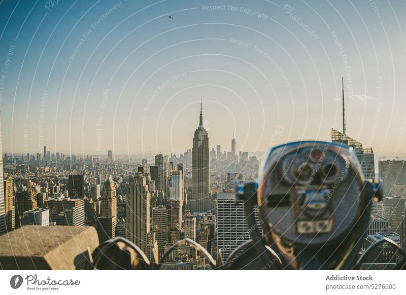 Viewpoint on city with binocular viewpoint observe empire state building cloudless blue sky skyscraper megapolis downtown new york usa united states america