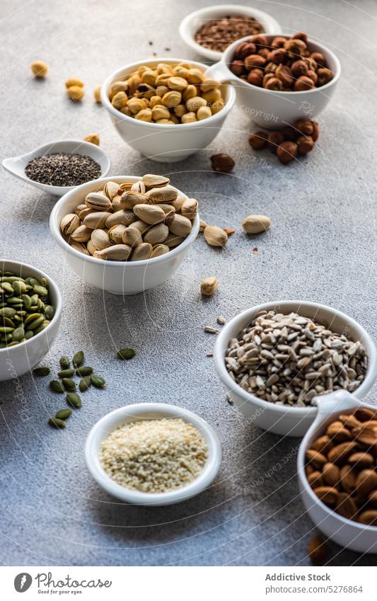 Bowls full of nuts and seeds almond bowl ceramic snack flax food frame hazelnut keto meal assortment diet organic pistachio chia nutrition protein healthy