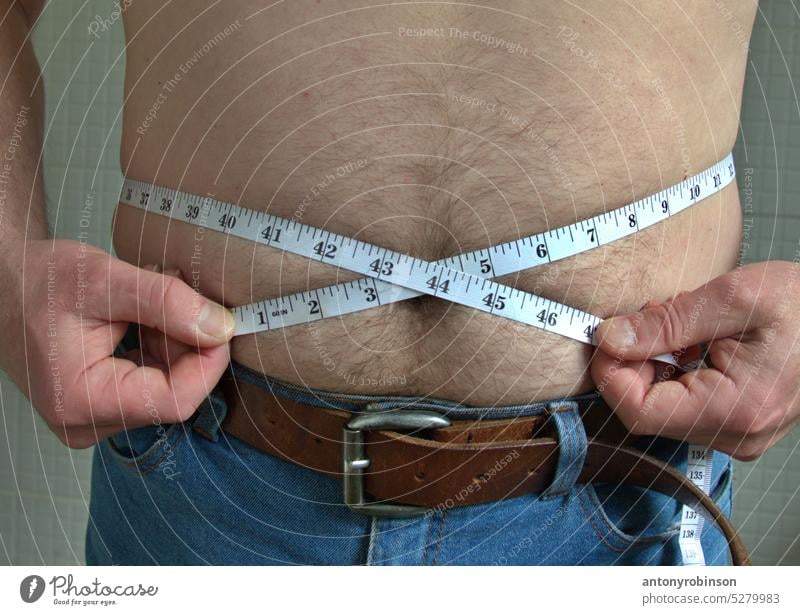 https://www.photocase.com/photos/5279983-mans-waistline-being-measured-person-man-weight-photocase-stock-photo-large.jpeg