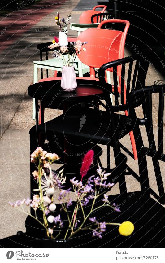 street cafe Café Bistro Gastronomy Chair chairs Table flowers Bouquet variegated Empty Bakery shop Town Sidewalk Sunlight