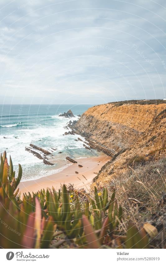 View of Alteirinhos Beach and the dry scenery near Zambujeira do Mar, Odemira region, western Portugal. Wandering along the Fisherman Trail, Rota Vicentina