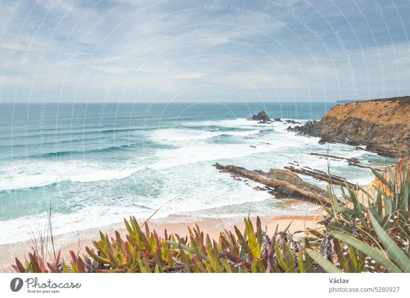 Rocky and stony cliffs and sandy beach is known as Alteirinhos Beach near Zambujeira do Mar, Odemira region, western Portugal. Wandering along the Fisherman Trail, Rota Vicentina