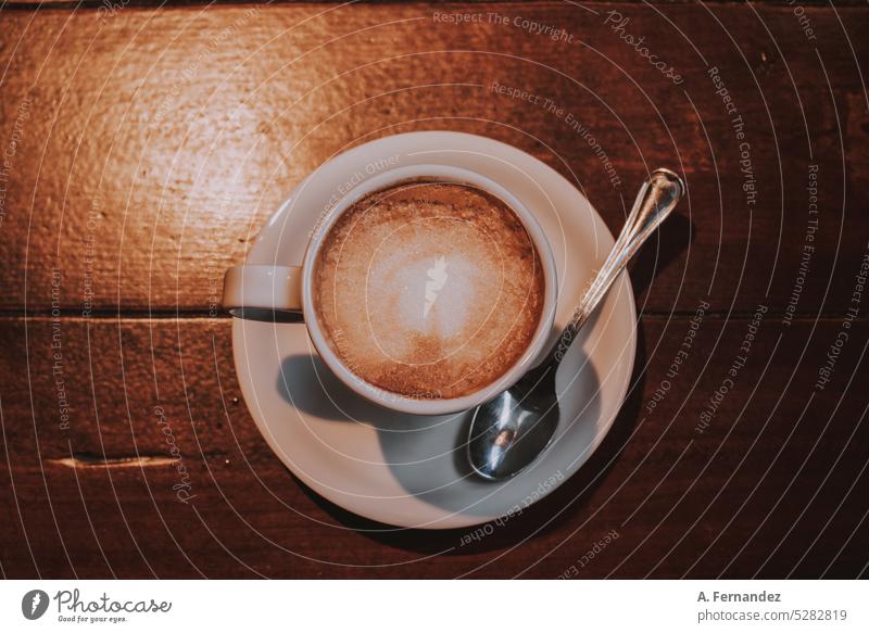 A cup of coffee with a small teaspoon on a wooden table Wooden table Wooden board teaspoon. coffee spoon Café Cafeteria Café au lait Coffee Cup Coffee cup