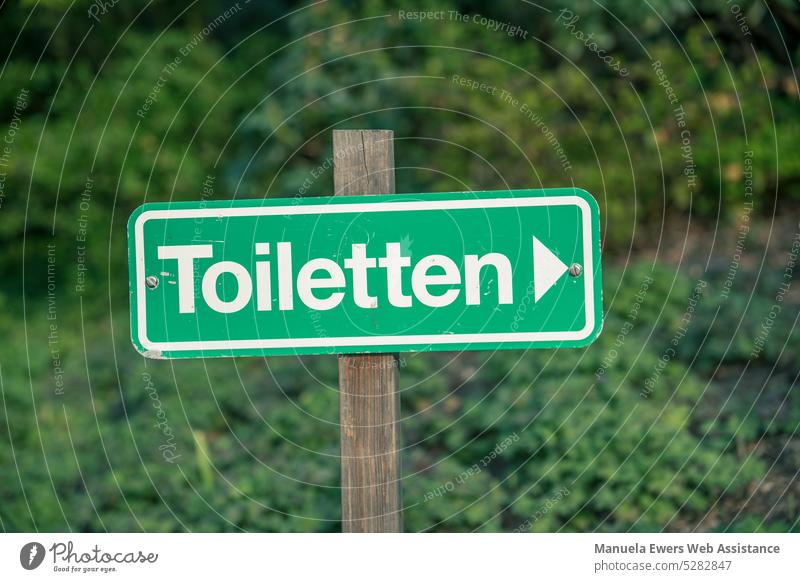 a-sign-pointing-to-the-nearest-toilet-a-royalty-free-stock-photo-from