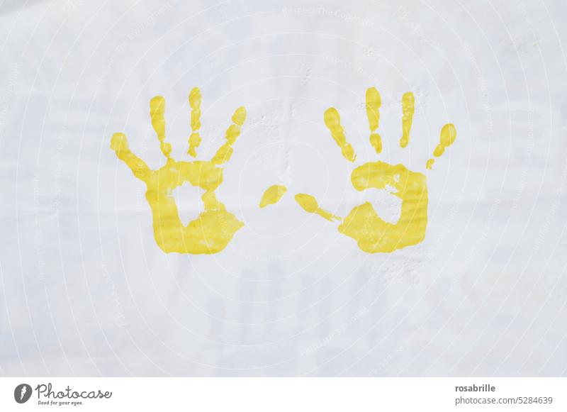 yellow imprint of two children's hands Hand Colour Finger paint Imprint handprint Child game Painting (action, artwork) Art Creativity Fingerprint