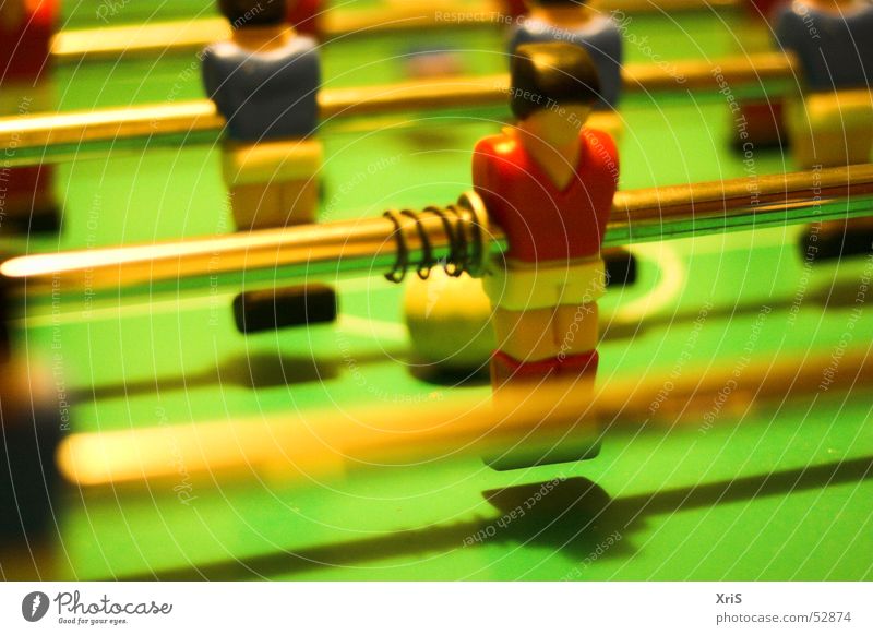 In the second row Table soccer Attacker Sports team Second row Adversary Piece Ball Metal coil Rod Close-up Detail Colour photo Perspective