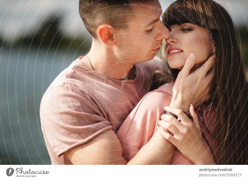 Loving young couple kissing and hugging in outdoors. Love and tenderness, dating, romance, family, anniversary concept. love day valentines city beautiful woman