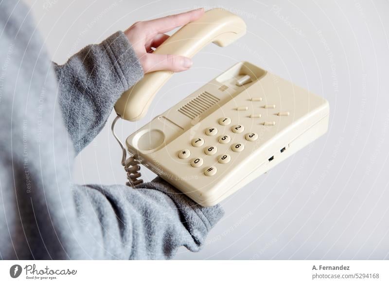 Woman answering an old retro telephone device. concept of changes in ways of communication Telephone old phone Telephone connection Telephone number