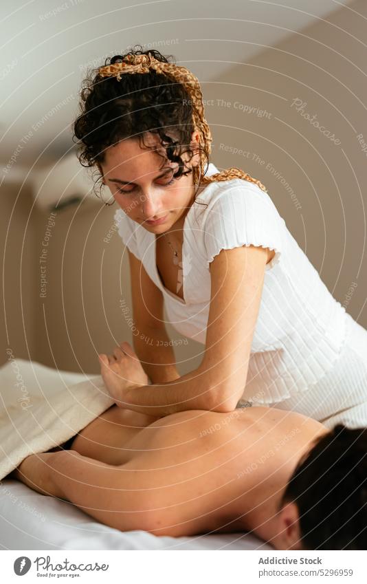 https://www.photocase.com/photos/5296959-masseuse-massaging-back-of-client-at-spa-man-photocase-stock-photo-large.jpeg