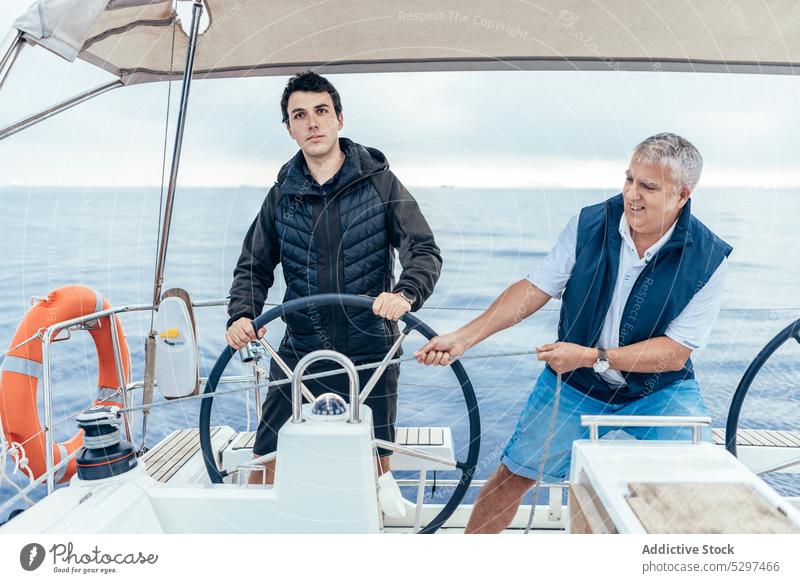 Serious men riding yacht in sea ride trip water confident boat ocean sail nature vacation travel journey male vessel adventure cruise wave transport ripple