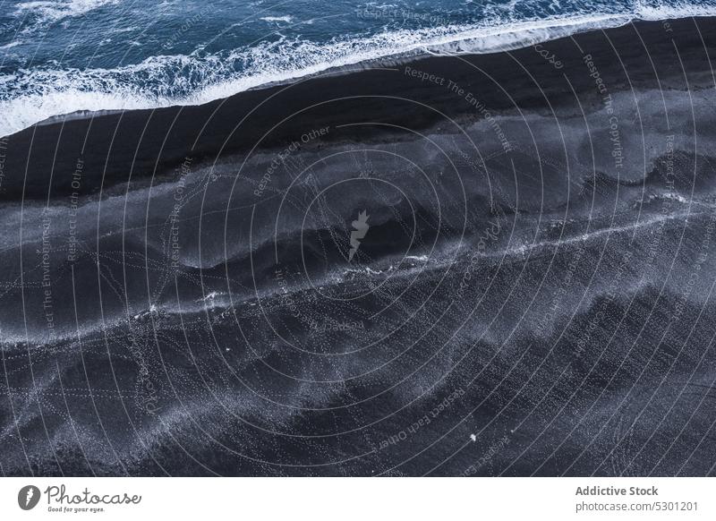 Winter landscape with foamy ocean and volcanic black sandy beach ice nature coastline sea seashore frozen cold iceland seascape wavy motion surface climate