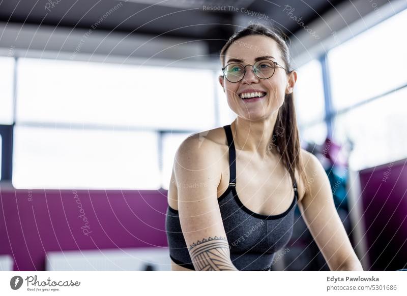 Portrait of a athletic young woman in a gym wellness wellbeing bodybuilder sporty lifting biceps muscles barbell bodybuilding people muscular adult person