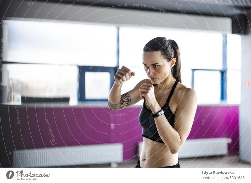 Portrait of a young woman boxing in a gym wellness wellbeing bodybuilder sporty lifting biceps muscles barbell bodybuilding people muscular adult person