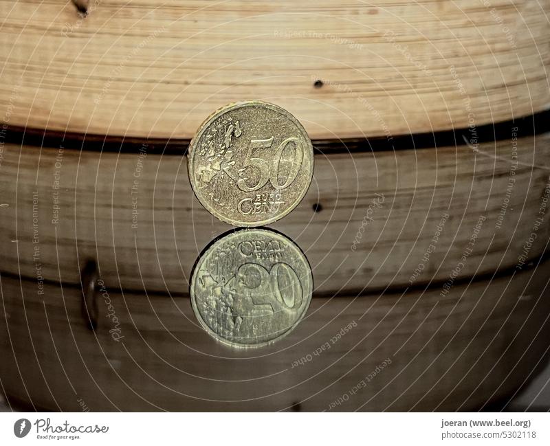 50 cent piece on mirror surface with bamboo basket in background 50 cents Money money Euro Cent cent pieces euro cents Coins Loose change Paying small change
