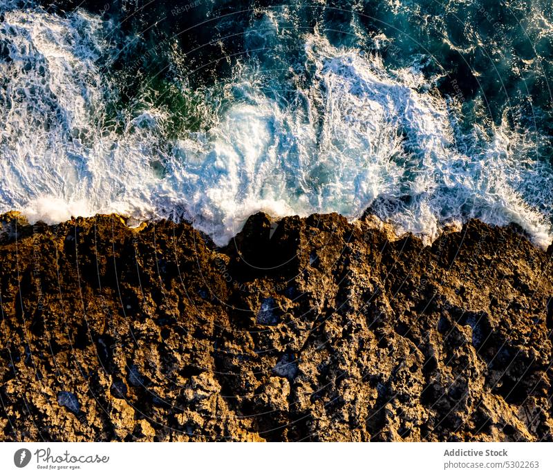 Stormy sea with foamy waves near rocky shore cliff splash stormy water edge nature ocean power coast ciutadella de menorca scenic spain seascape summer stone