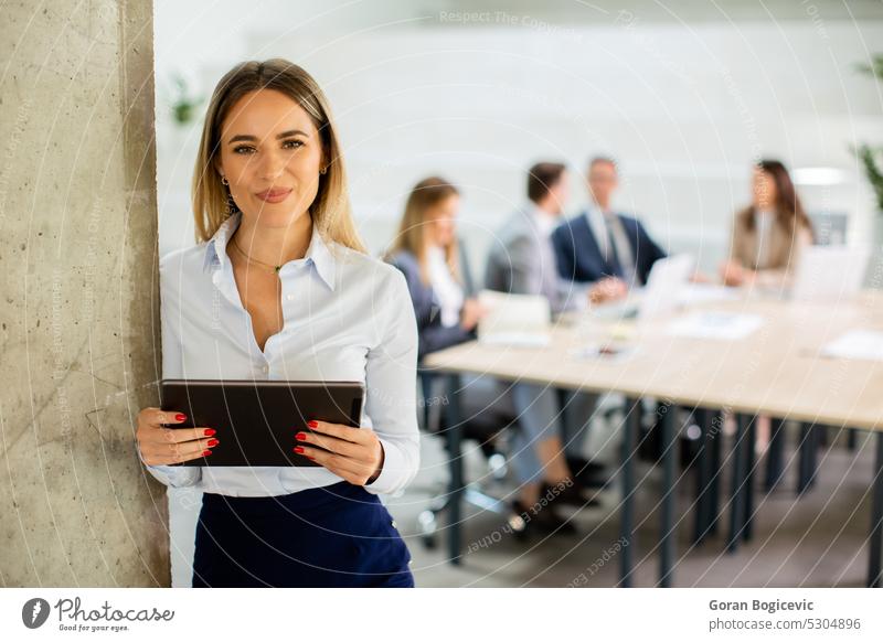 Young business woman with digital tablet in the office hallway project employee businesswoman businessman team people job career occupation enterprise