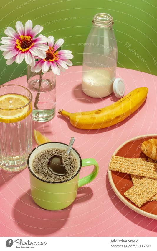 Delicious breakfast on pink table banana flower beverage coffee water drink milk fruit lemon vase fresh cup bottle tasty delicious blossom morning glass dessert