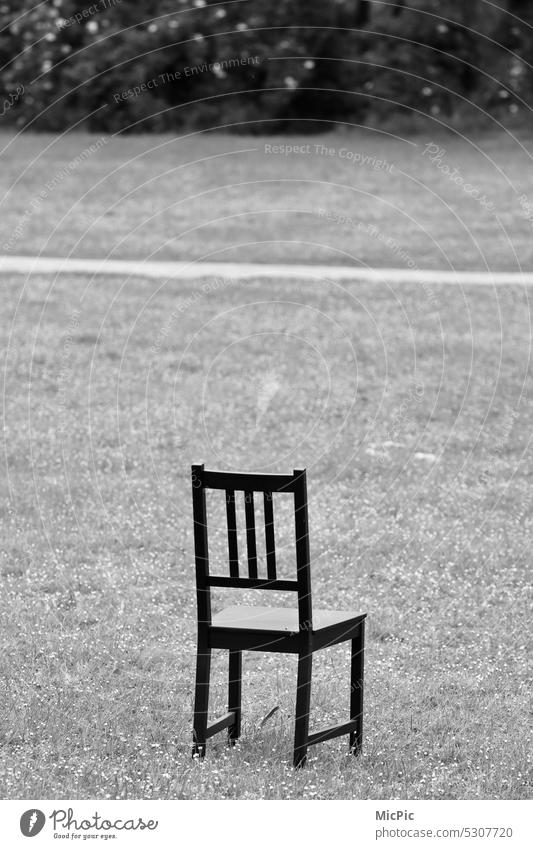 A forgotten chair on a meadow Chair Solo entertainer forsake sb./sth. Loneliness Storyteller Forget Stage Meadow Open-air theater Seating Furniture Deserted