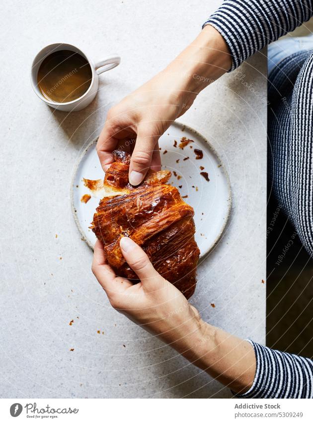 Faceless person eating delicious croissant with coffee breakfast espresso morning cup food tasty fresh beverage appetizing table yummy dessert meal sweet drink