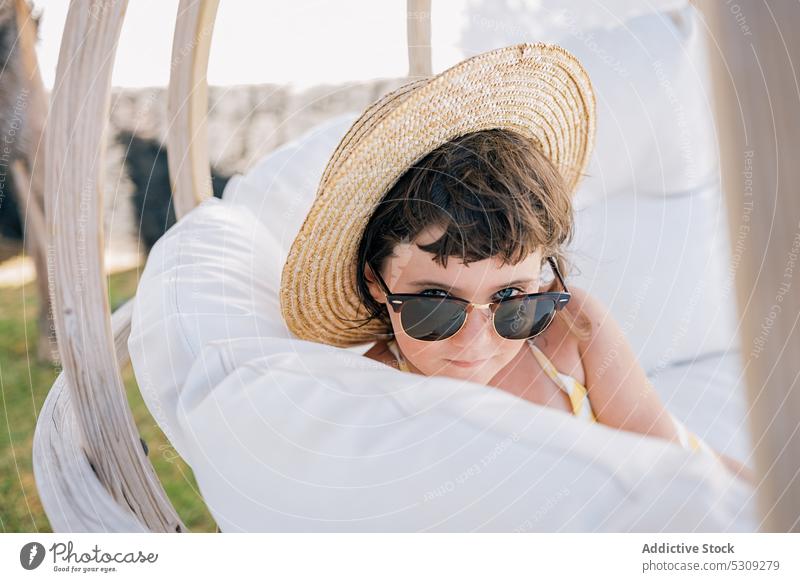 Cute girl in sunglasses and straw hat tent summer child trendy rest vacation cool nature relax weekend countryside holiday sit daytime appearance outfit kid