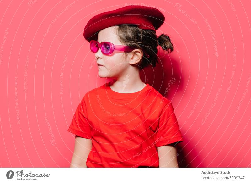 Funny girl in red casual shirt and beret making superhero pose while  looking at camera - a Royalty Free Stock Photo from Photocase