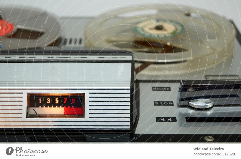 A vintage reel-to-reel tape recorder with a vu meter and a large switch  from the seventies - a Royalty Free Stock Photo from Photocase