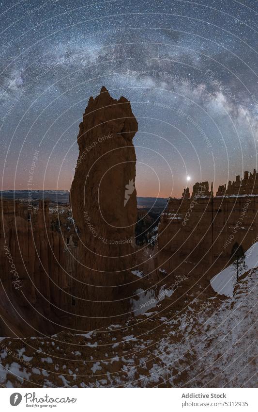 Amazing view of rocky formations in winter at night mountain uneven rough cliff canyon scenery bryce canyon national park nature landscape surface sky star