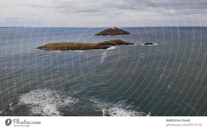 Aerial view of rocky cliffs in rippling sea seascape ocean wave overcast sky shore ireland cloudy water nature calm foam seaside storm seashore picturesque