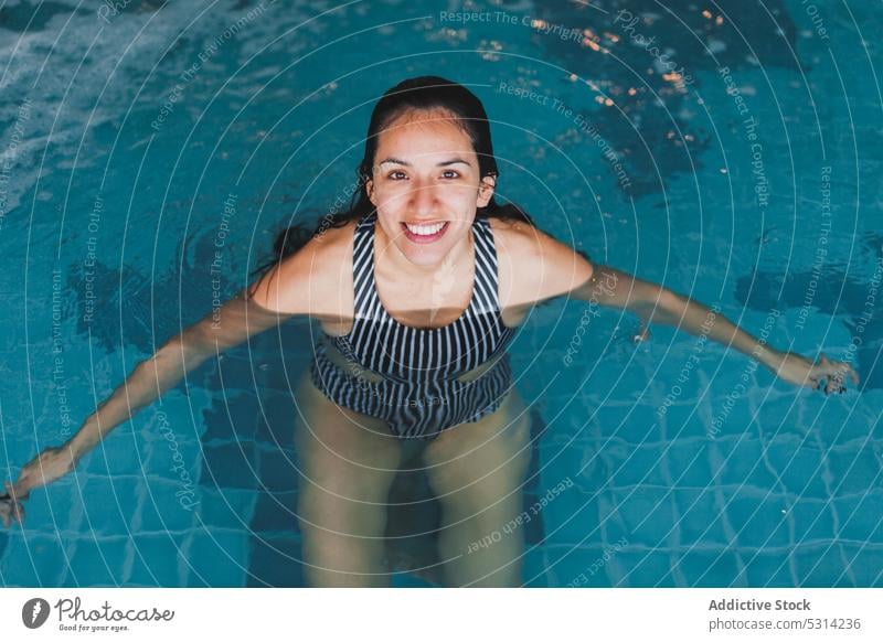 Happy swimming female in pool - a Royalty Free Stock Photo from Photocase