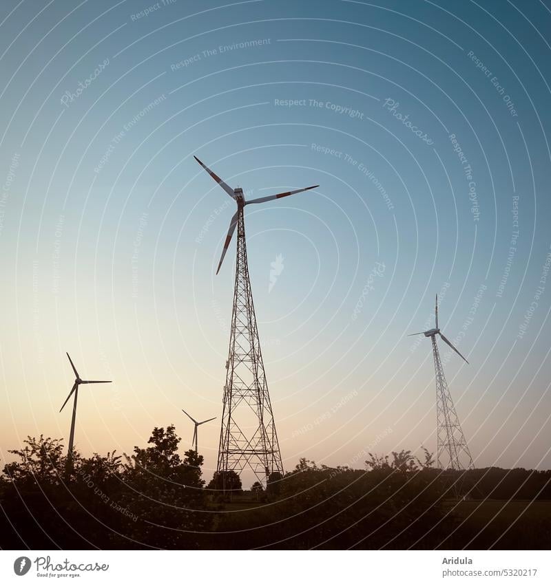 Four wind turbines at dusk windmills Wind energy plant stream Energy Energy industry Renewable energy Eco-friendly Electricity Sustainability Alternative