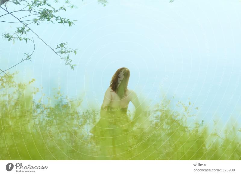 The woman by the river Woman Rear view Long-haired Brunette Backless bank Lake grasses River bank Lakeside Water Nature Dreamily dream image