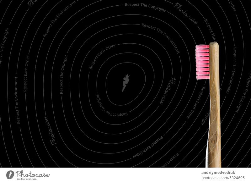Eco friendly product concept. Zero waste bamboo toothbrushes with pink bristle isolated on black background. Biodegradable material. Natural organic wooden brushes. Safe the earth. Copy space