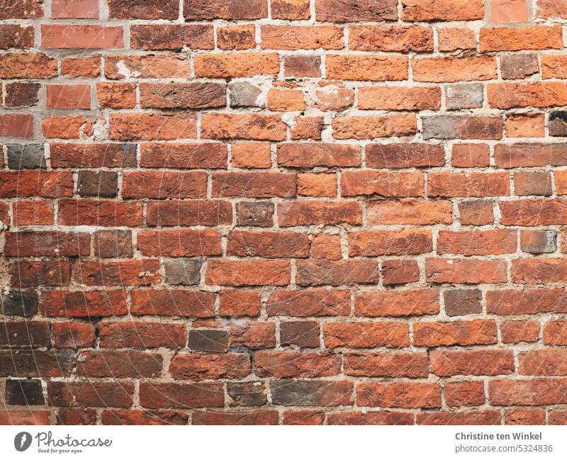 An old weathered brick wall Brick facade Brick wall Wall (building) Wall (barrier) Facade Old Bricks repaired Red Stone Structures and shapes vintage Building