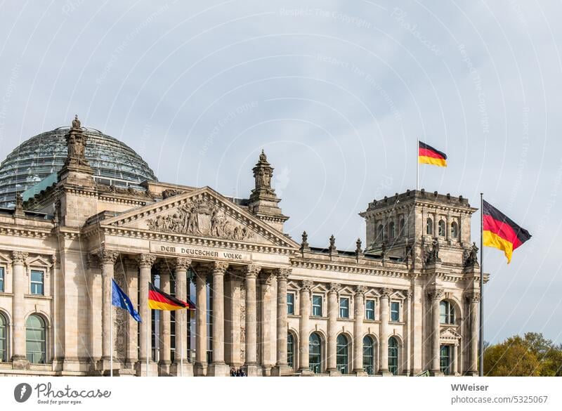 The Reichstag and the German Bundestag in Berlin with waving flags Government Parliament Government building Germany Republic Capital city Seat of government
