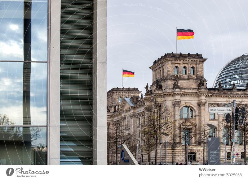 The Reichstag and the German Bundestag in Berlin with waving flags and another government building Government Parliament Government building Germany Republic