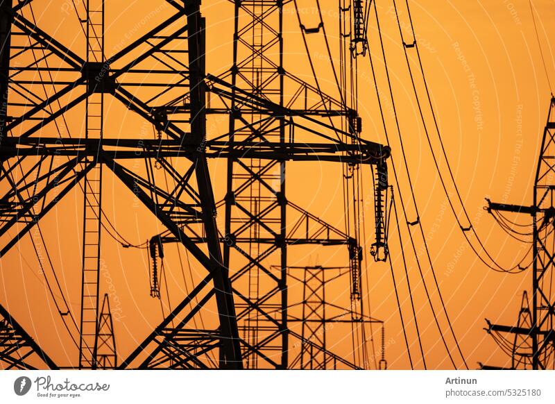 High voltage electric transmission tower. High voltage power lines on electric pylon against a sunset sky. Electrical infrastructure. Energy crisis. Electric power distribution. Energy distribution.