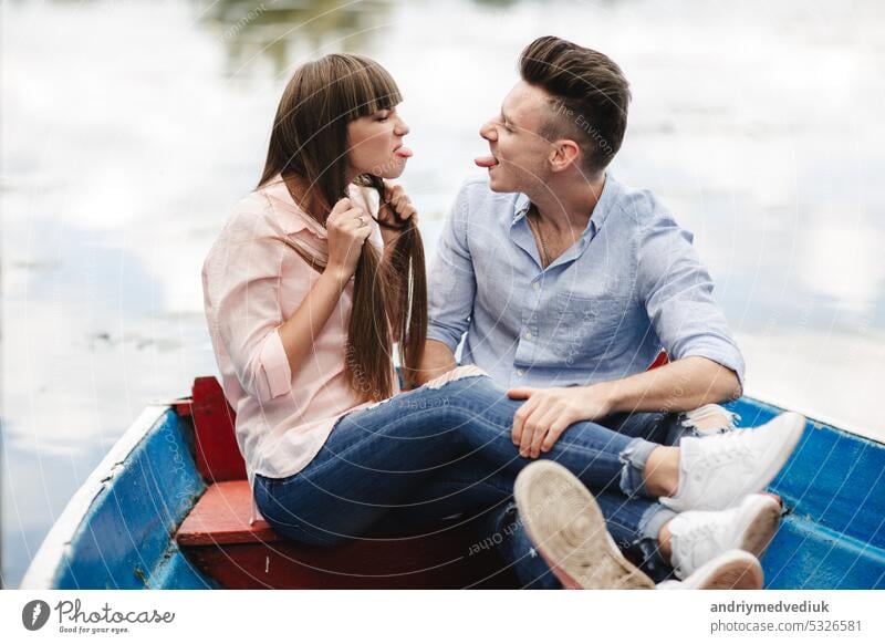 crazy young couple emotionally having fun, kissing and hugging outdoors. Love and tenderness, romance, family, emotions, fun. having fun together beach happy