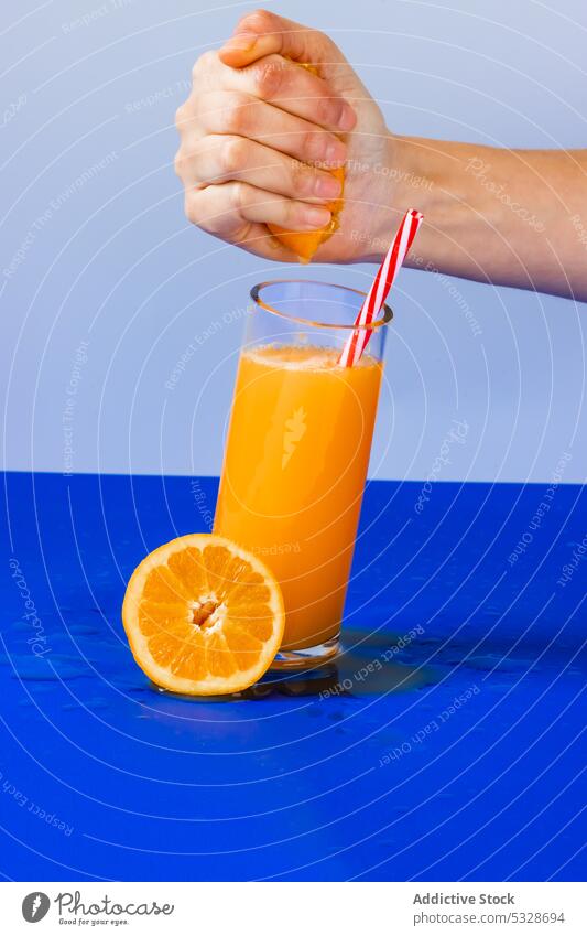 Crop person with glass of orange juice cocktail drink refreshment slice squeeze citrus cup delicious natural liquid healthy beverage crop vitamin tasty fruit