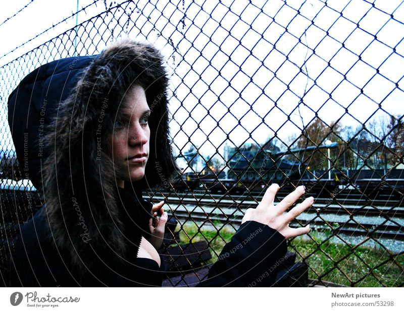 fence Model Woman Fence Coat Hand Fingers War Military building Railroad Railroad tracks Barbed wire Winter Hooded (clothing) Armor-plated Train station Looking