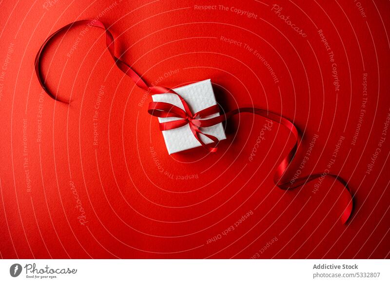 White gift box with red ribbon present wrap background wrapping beautiful bright card color colorful concept festive holiday minimalism overhead white christmas