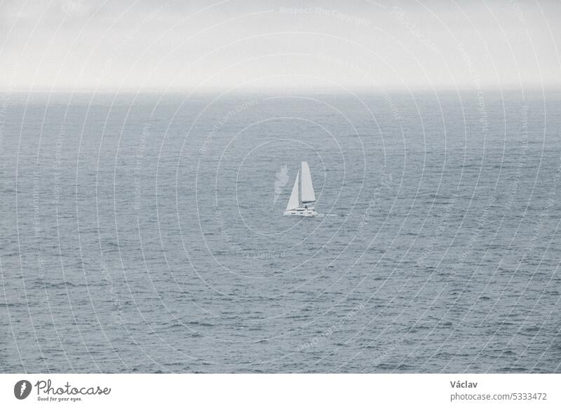 White sailfish sails through the stormy Atlantic Ocean in rainy weather in southern Portugal sailboat sport transport wave ship wind yacht ocean romantic