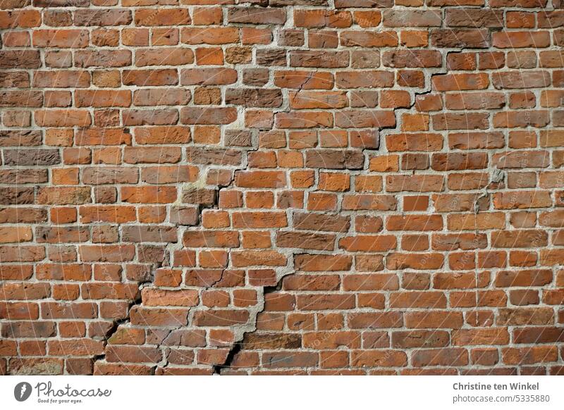 Clear cracks in an old brick facade Brick wall Crack & Rip & Tear Brick facade Bricks Old Facade Wall (barrier) Wall (building) repaired Red Stone